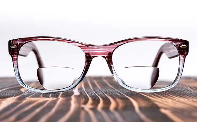 bifocal lenses glasses on a wooden board